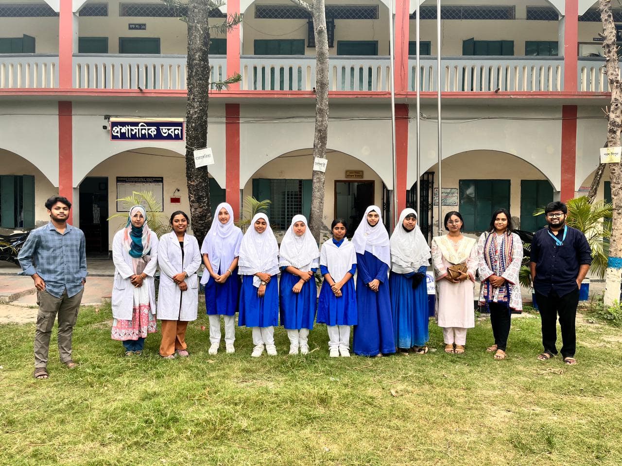 The SoulConnect team with students and school staff outside the administrative building