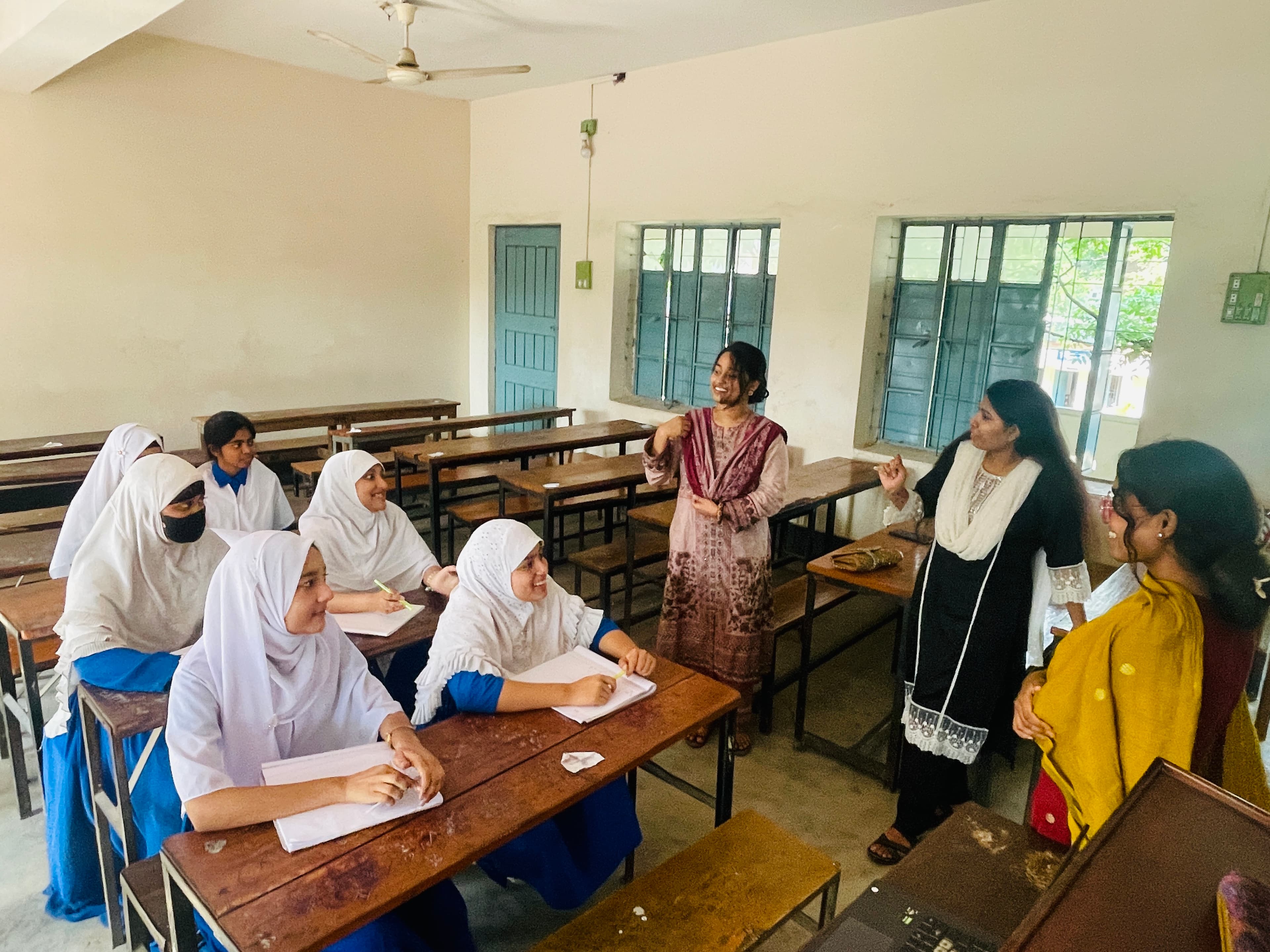 SoulConnect team members sharing a light, warm moment with students